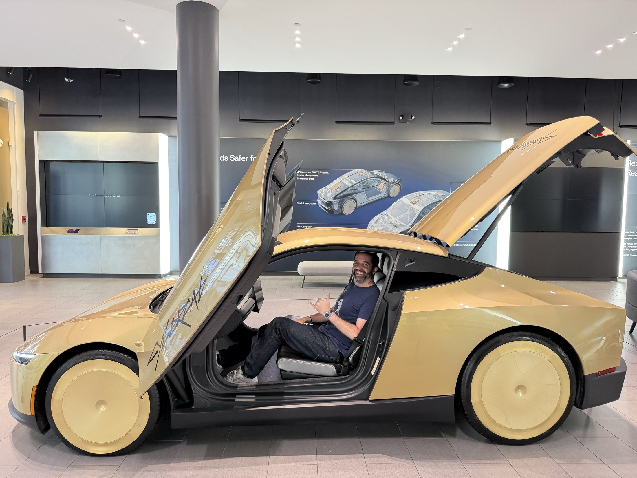 Michael Rihani sitting inside a Tesla Cybercab